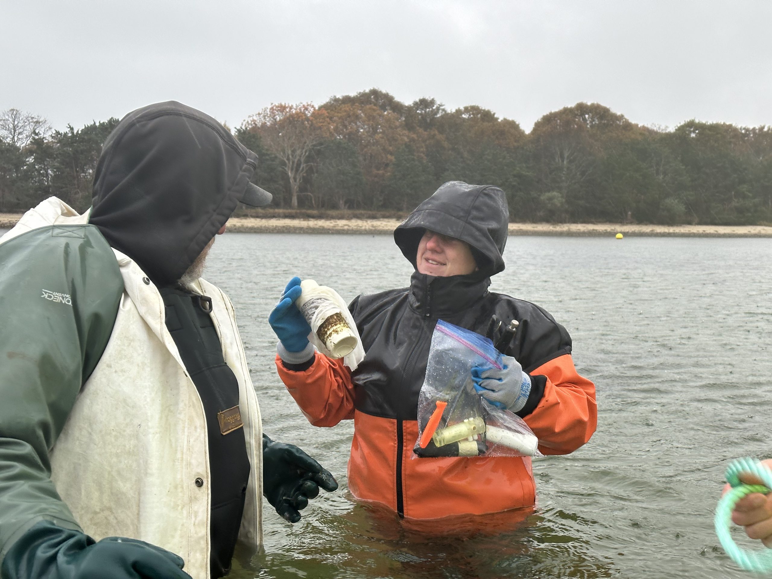 Rachel Hutchinson (right) spoke with a Yarmouth shellfish farmer (left) as she carried a spool of kelp and a bag full of underwater temperature sensors to where the kelp would be anchored on November 9, 2023. 